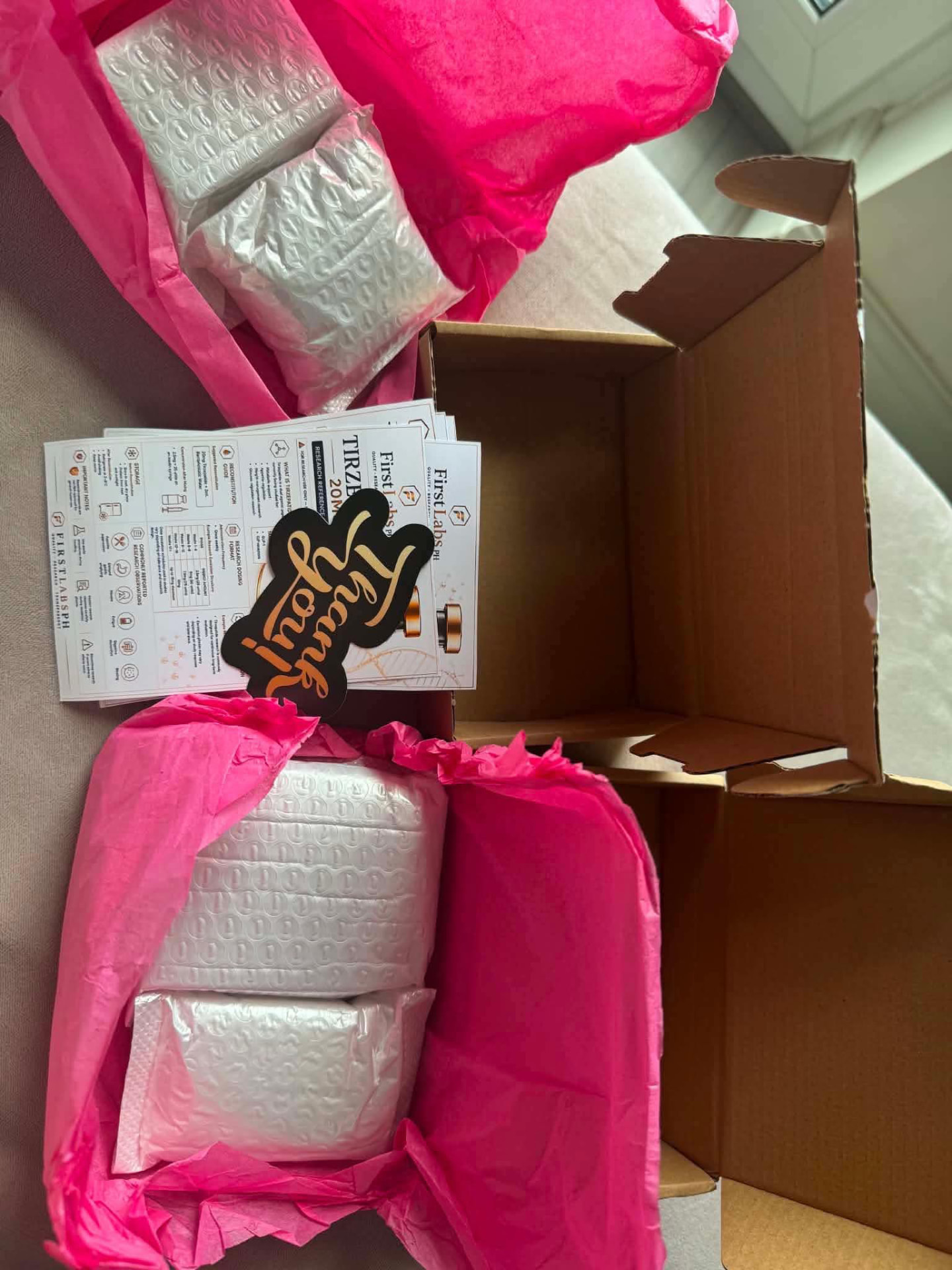 Tirzepatide 20mg research guides with FirstLabs PH thank-you sticker and bubble-wrapped vials in pink tissue