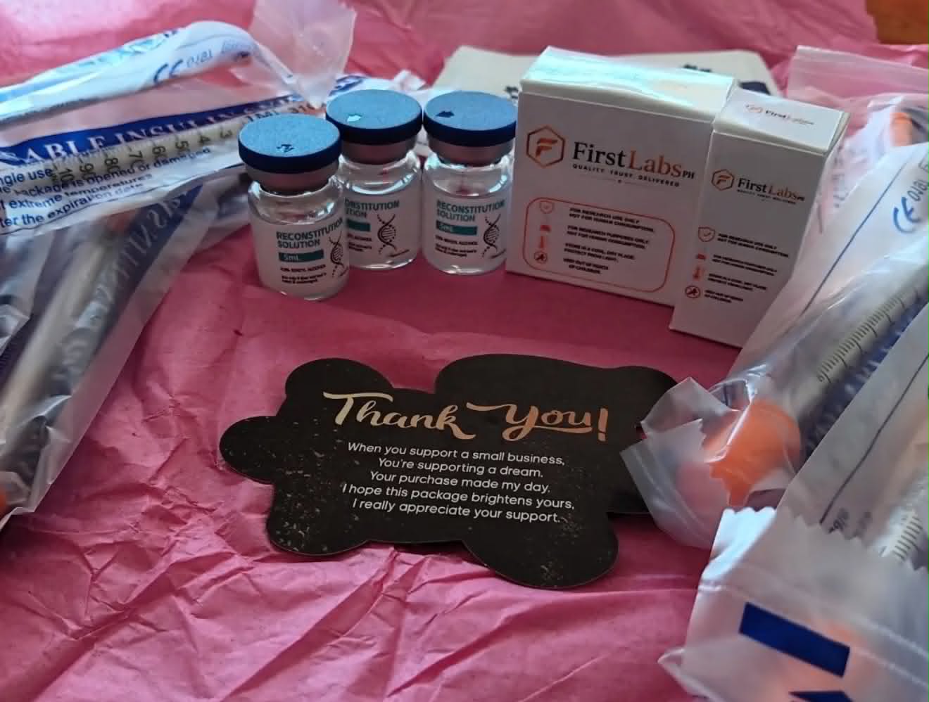Customer unboxing FirstLabs PH order with thank-you card