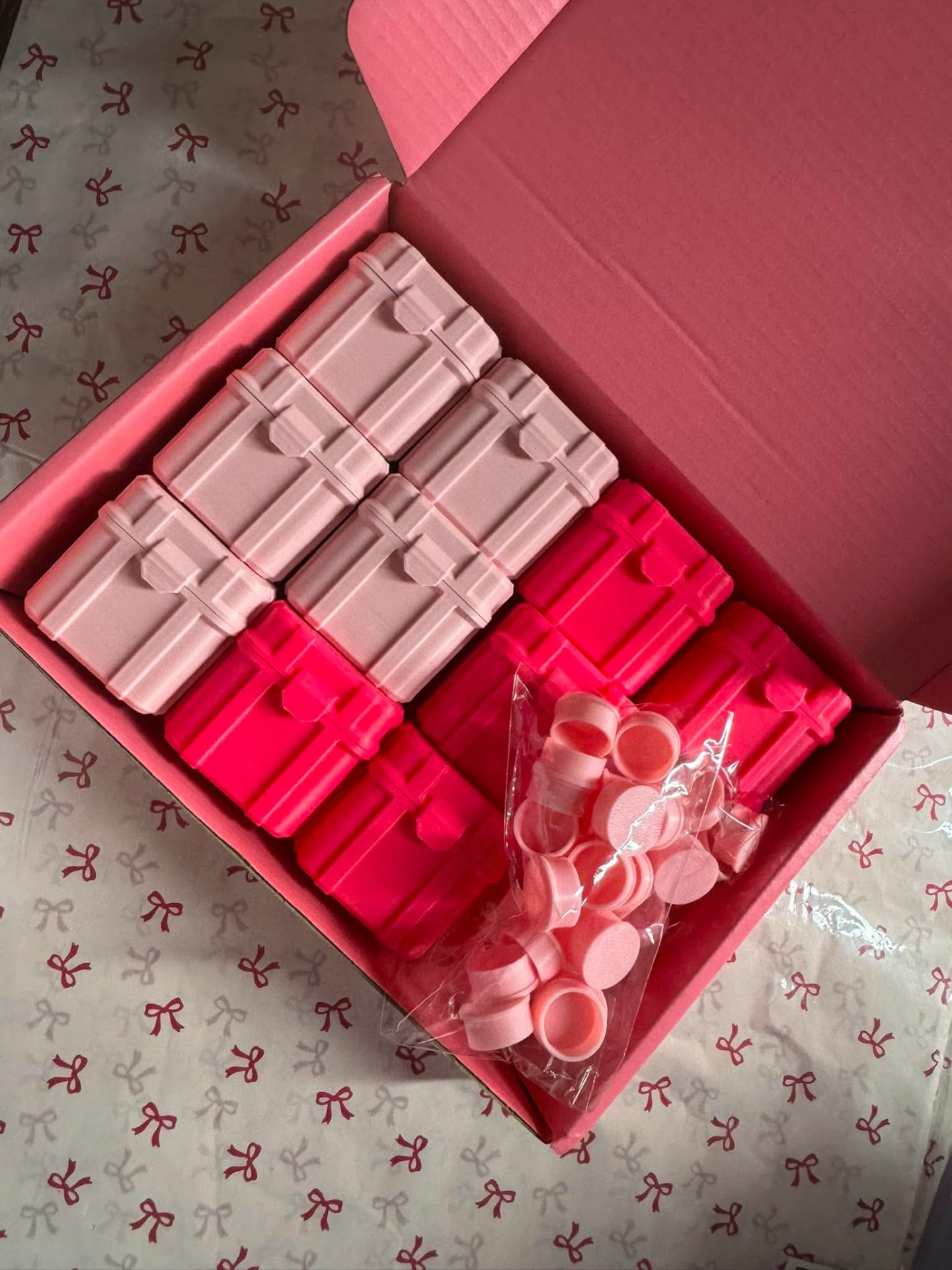 Box of pink FirstLabs PH protective vial cases and flip caps ready for packing